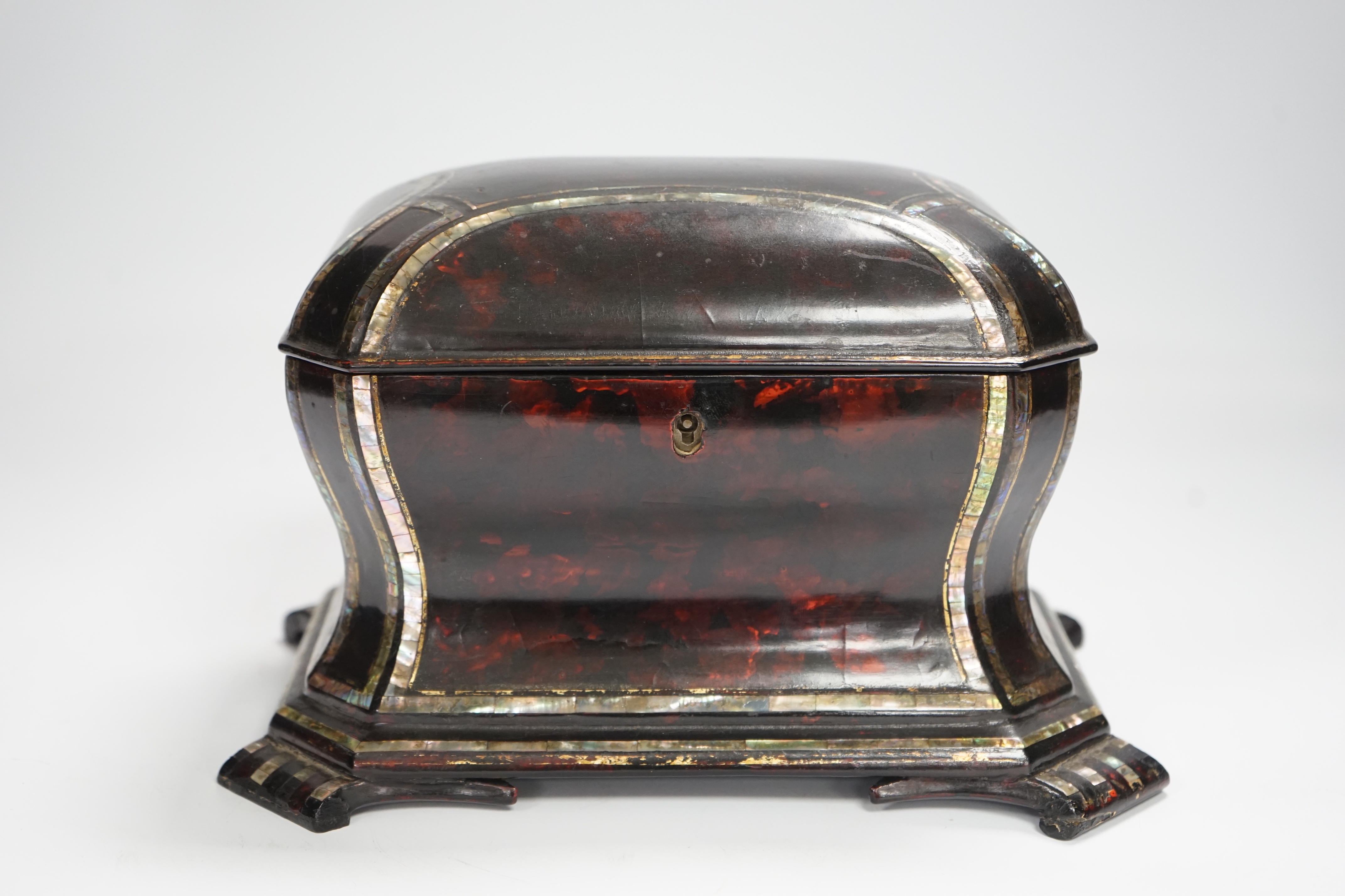 A Victorian papier mache tea caddy, stamped Jennens and Bettridge, in the form of a sarcophagus with inset mother of pearl banding, with two internal lidded compartments, 15cm high